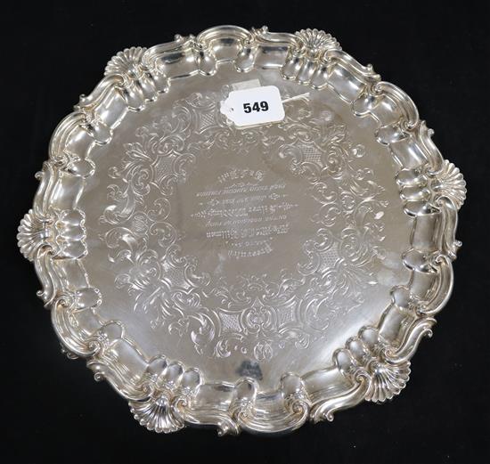A silver presentation salver with scroll and shell border and scrolled feet, Sheffield 1851, Henry Wikinson Co. Ltd